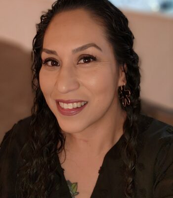 Cibonay Jimenez's headshot. A person with medium olive skin and long black hair