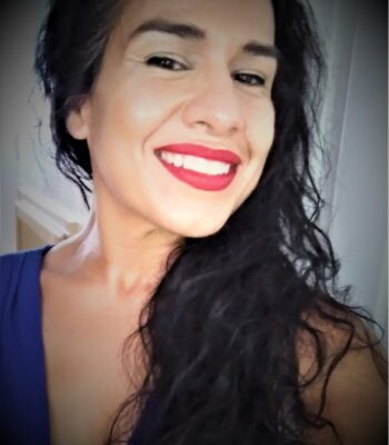 Michelle Morales' headshot; a person with medium olive skin and long dark brown hair